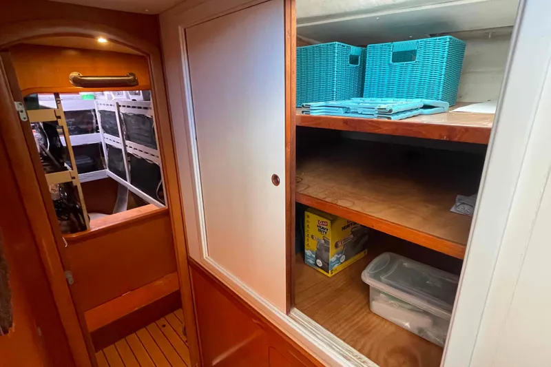 Slide: The Image of Interior of 2003 Lagoon 410-S2 yacht with wooden finishes and compact bathroom. - 49