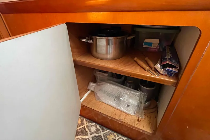 Slide: The Image of Interior of 2003 Lagoon 410-S2 yacht with wooden decor and starfish wall art. - 50