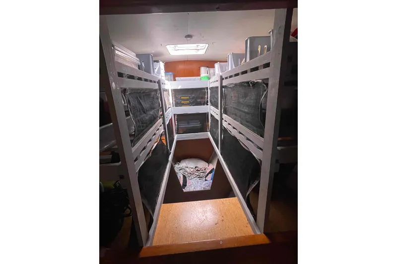 Slide: The Image of Interior storage area of a 2003 Lagoon 410-S2 yacht with shelves and blue baskets. - 51