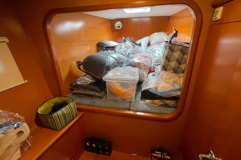 Slide: The Image of Interior of 2003 Lagoon 410-S2 catamaran with seating, table, and navigation station. - 55