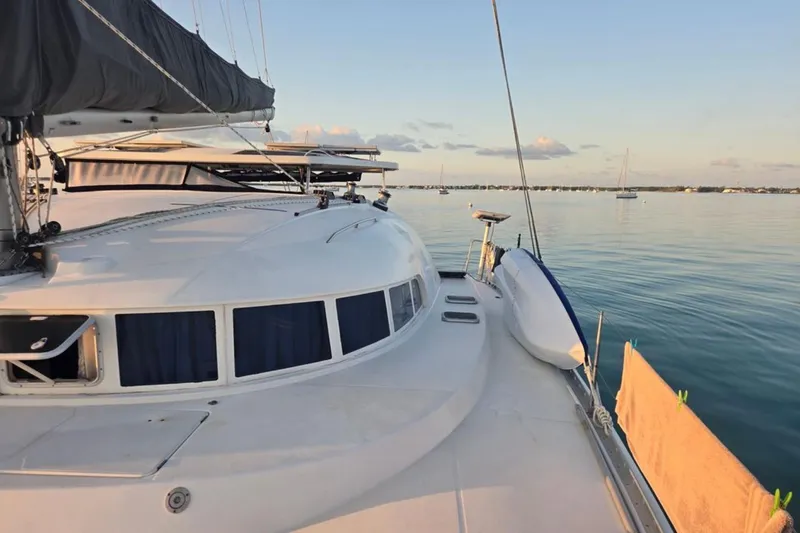 Slide: The Image of 2003 Lagoon 410-S2 catamaran docked, view of deck and mast cover. - 84