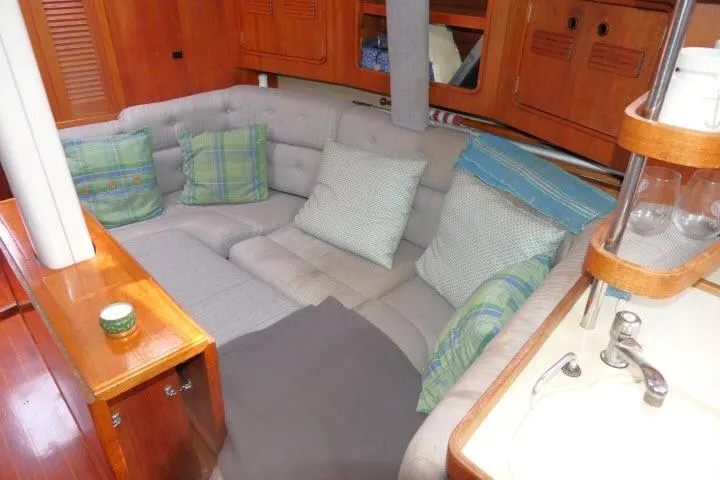 Slide: The Image of Cozy interior of 1989 C&C 37/40+ sailboat with cushioned seating and wooden cabinetry. - 10