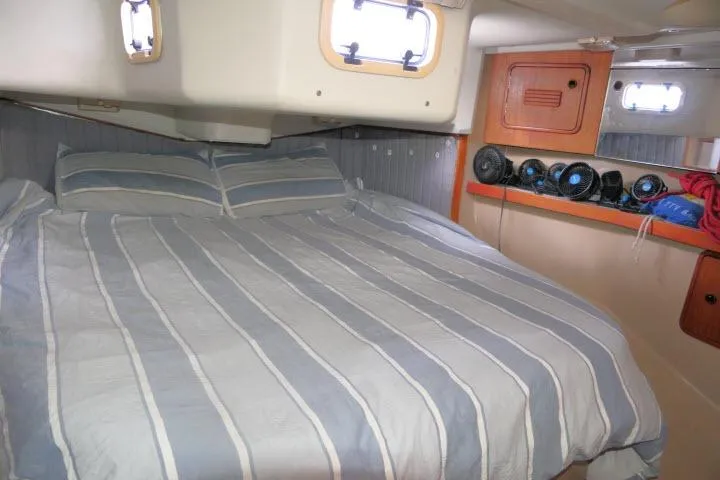 Slide: The Image of Cozy cabin interior of 1989 C&C 37/40+ sailboat with striped bedding. - 31