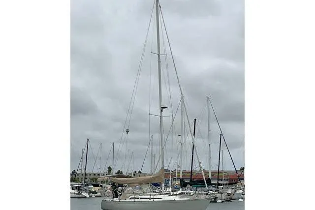 Slide: The Image of 1989 C&C 37/40+ sailboat docked in a marina under cloudy skies. - 68
