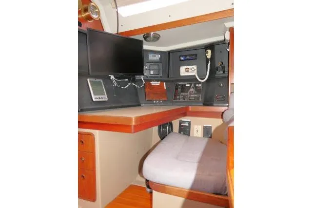 Slide: The Image of Navigation station inside 1989 C&C 37/40+ sailboat with electronics and seating. - 13