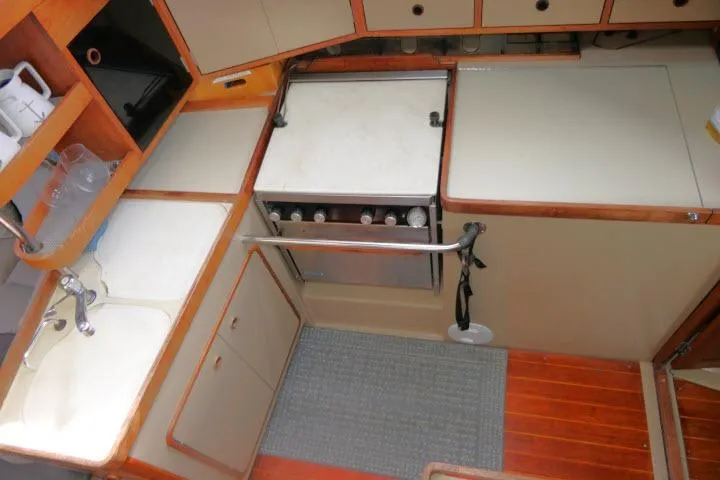 Slide: The Image of 1989 C&C 37/40+ yacht kitchen with stove, sink, and storage cabinets. - 16
