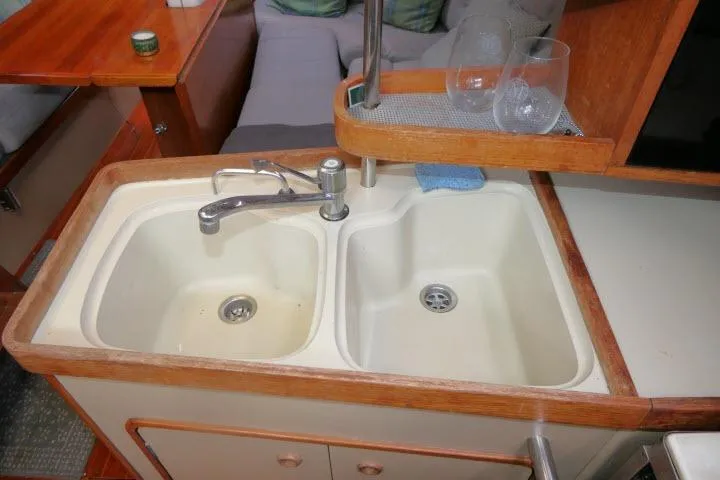 Slide: The Image of 1989 C&C 37/40+ yacht kitchen sink with dual basins and wooden trim. - 19