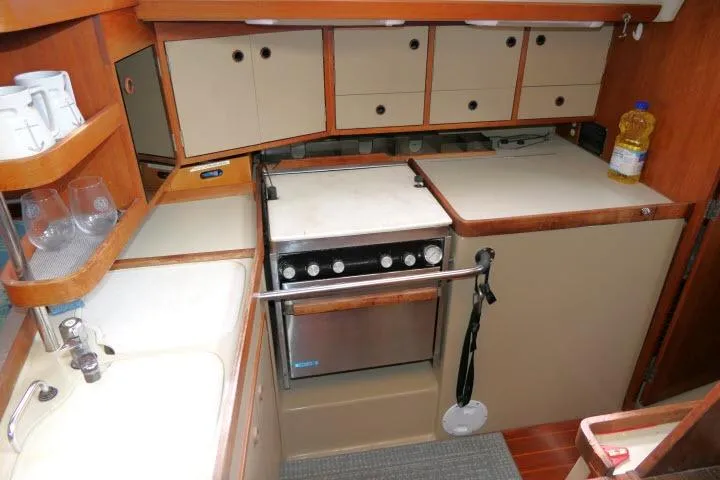 Slide: The Image of 1989 C&C 37/40+ yacht kitchen with stove, sink, and storage cabinets. - 20