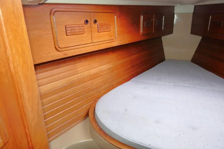 Slide: The Image of 1989 C&C 37/40+ yacht interior with wooden cabinetry and cozy sleeping area. - 25