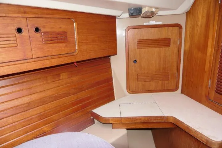 Slide: The Image of 1989 C&C 37/40+ yacht interior with wooden cabinetry and compact design. - 26