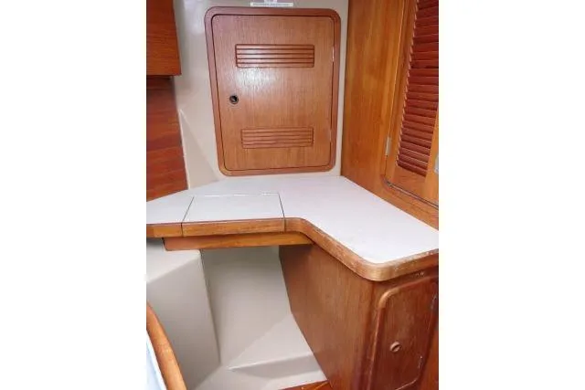 Slide: The Image of 1989 C&C 37/40+ yacht interior with wooden cabinetry and countertop. - 27