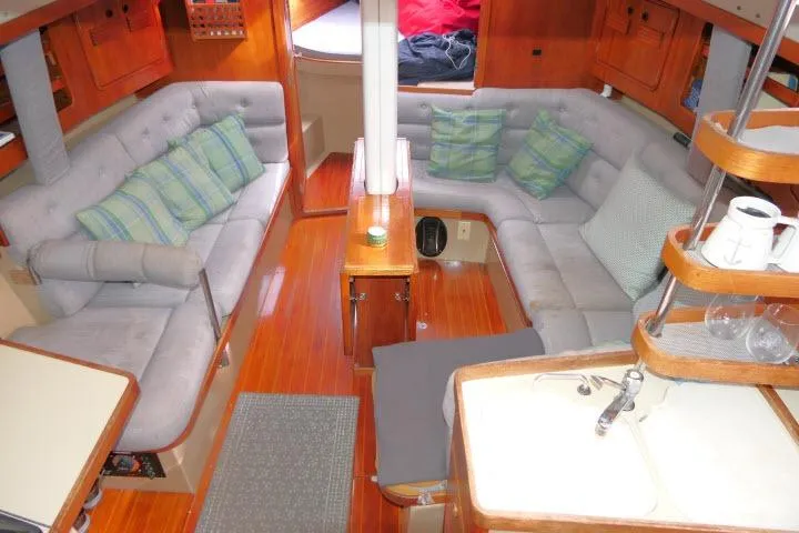 Slide: The Image of Interior of 1989 C&C 37/40+ sailboat with cozy seating and wooden finishes. - 3