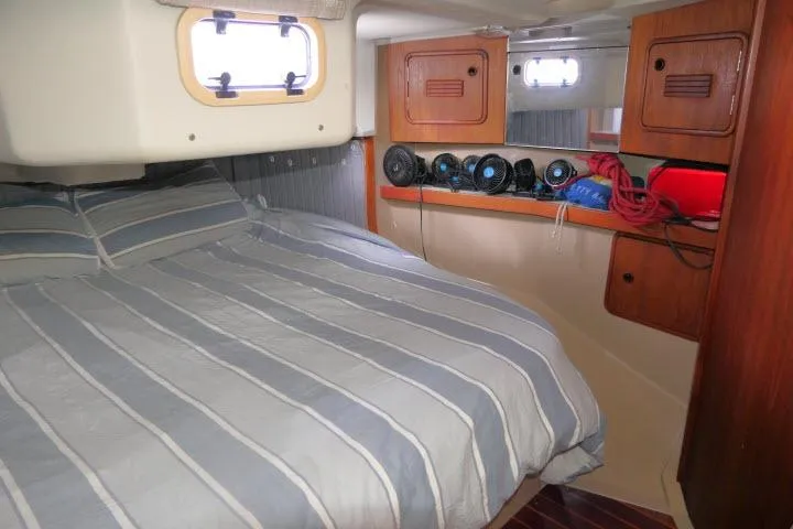 Slide: The Image of Cozy cabin interior of 1989 C&C 37/40+ sailboat with striped bedding and storage. - 32