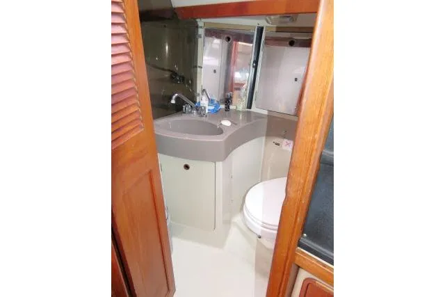 Slide: The Image of 1989 C&C 37/40+ yacht bathroom with sink, mirror, and toilet. - 34