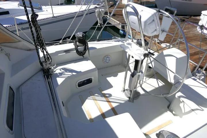 Slide: The Image of Cockpit of 1989 C&C 37/40+ sailboat with steering wheel and seating area. - 37