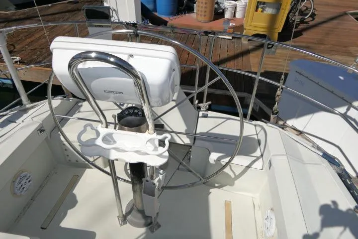 Slide: The Image of 1989 C&C 37/40+ sailboat cockpit with steering wheel and navigation equipment. - 38