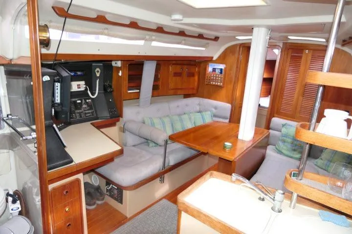 Slide: The Image of Interior of a 1989 C&C 37/40+ sailboat with cozy seating and navigation equipment. - 4