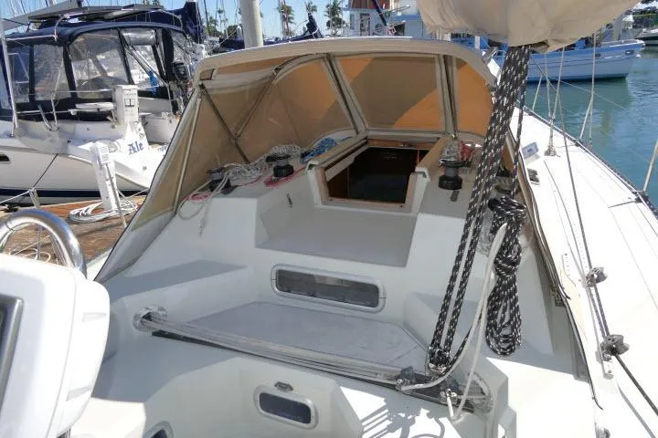 Slide: The Image of 1989 C&C 37/40+ sailboat cockpit with ropes and canopy in marina setting. - 42