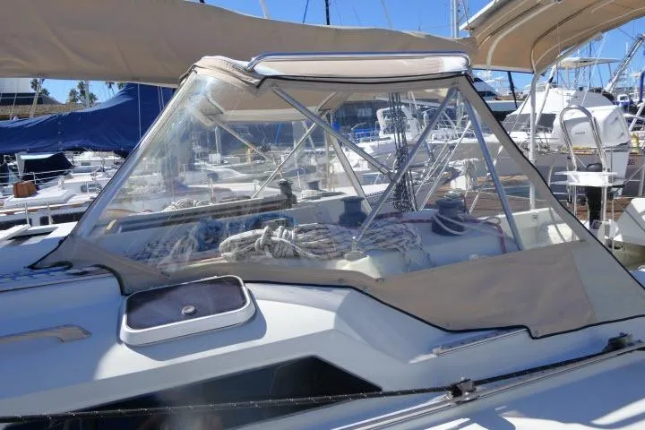 Slide: The Image of 1989 C&C 37/40+ sailboat with beige canopy and clear windshield in marina. - 45