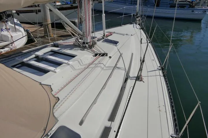 Slide: The Image of 1989 C&C 37/40+ sailboat deck with rigging, docked in marina. - 48