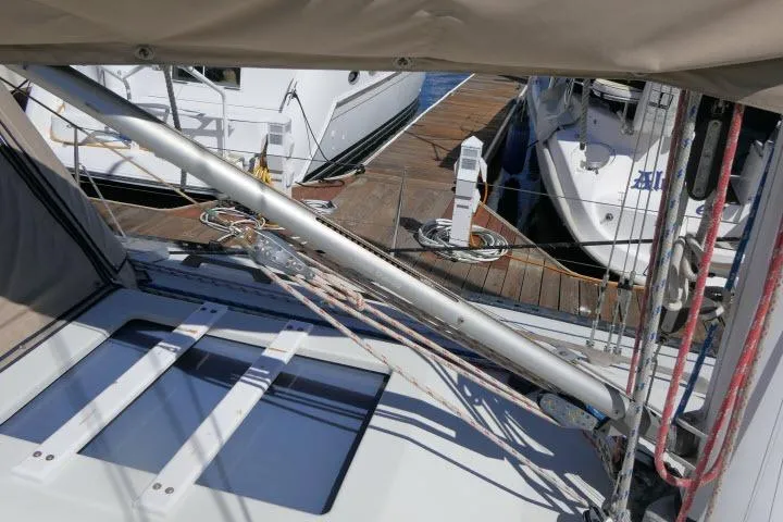 Slide: The Image of Sailboat deck view of 1989 C&C 37/40+ at marina with rigging and docked boats. - 49