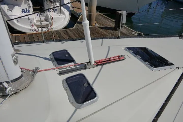 Slide: The Image of 1989 C&C 37/40+ sailboat deck with hatches and rigging at marina. - 50