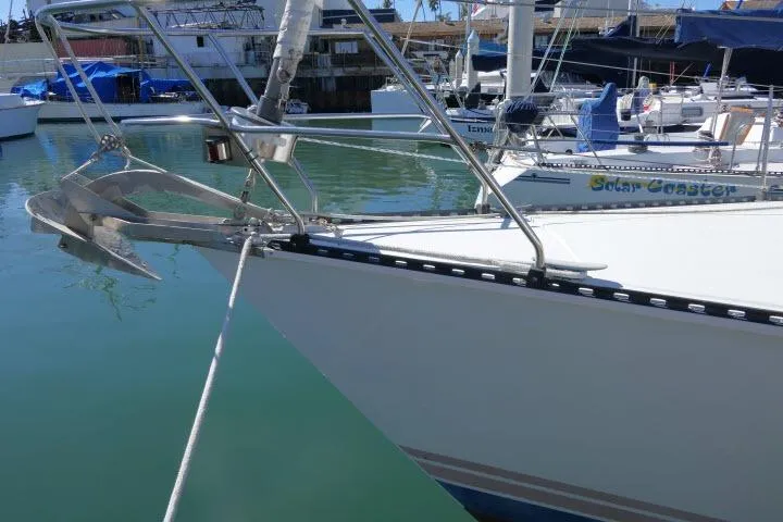 Slide: The Image of Bow of 1989 C&C 37/40+ sailboat docked in marina with anchor visible. - 54