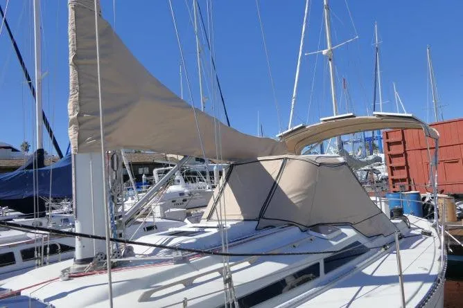 Slide: The Image of 1989 C&C 37/40+ sailboat docked at marina with beige sail cover. - 56