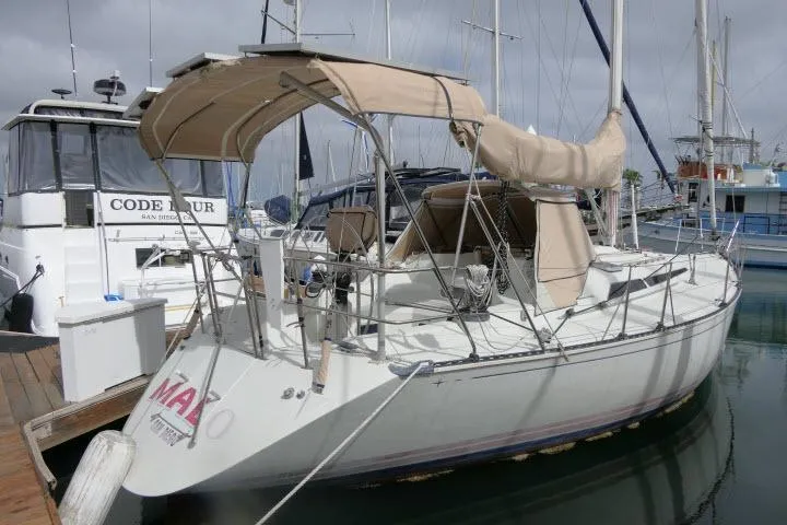 Slide: The Image of 1989 C&C 37/40+ sailboat docked at marina with beige canopy. - 59