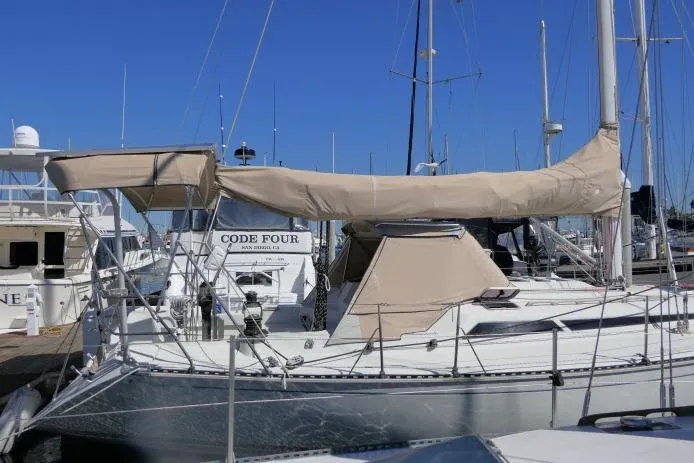 Slide: The Image of 1989 C&C 37/40+ sailboat docked at marina with beige covers. - 60