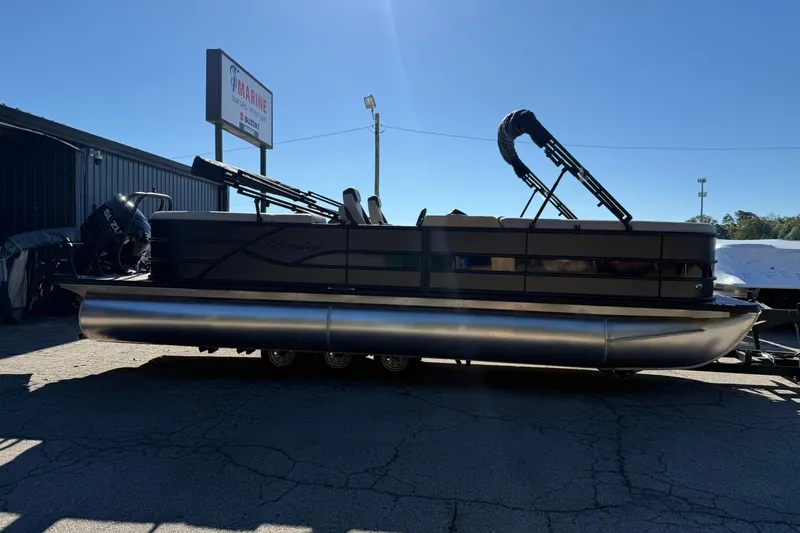 Slide: The Image of 2026 Bentley Pontoons Legacy 243 Navigator in a parking lot, side view. - 1