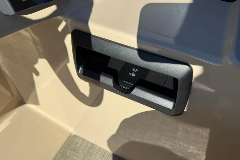 Slide: The Image of 2026 Bentley Pontoons Legacy 243 Navigator wireless charging dock detail. - 11