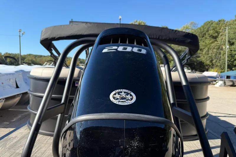 Slide: The Image of 2026 Bentley Pontoons Legacy 243 Navigator with 200 horsepower engine, docked outdoors. - 5