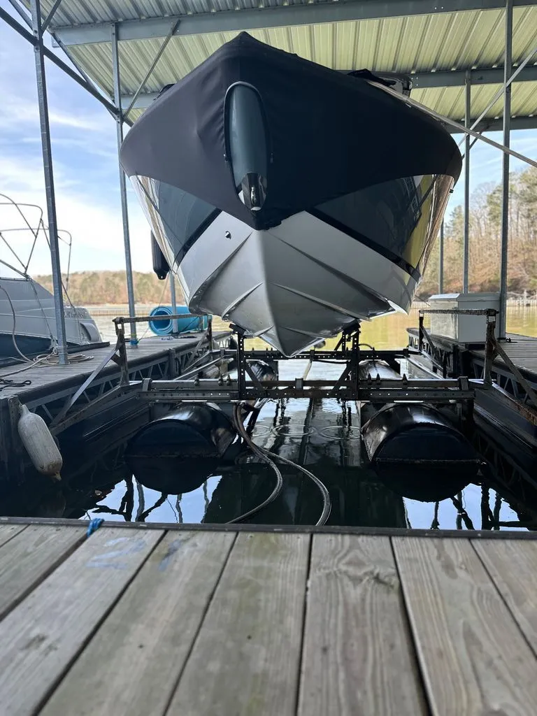 Slide: The Image of 2021 Cobalt R7 boat on a lift in a marina. - 18