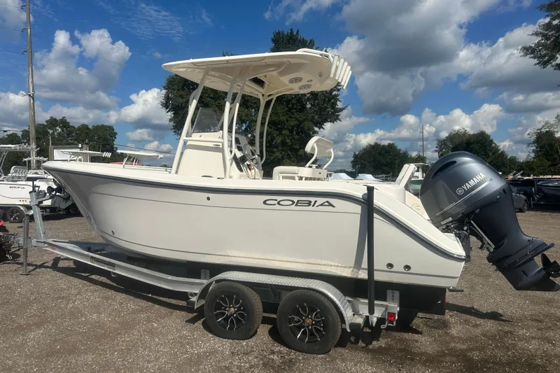 Slide: The Image of 2023 Cobia 220 Center Console boat on trailer with Yamaha outboard motor. - 10