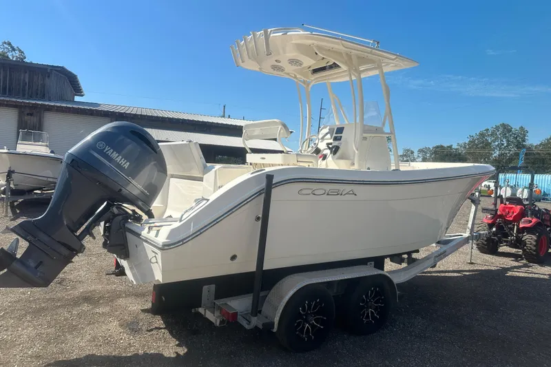 Slide: The Image of 2023 Cobia 220 Center Console boat with Yamaha engine on trailer, outdoor setting. - 14