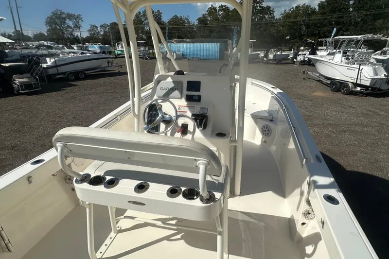 Slide: The Image of 2023 Cobia 220 Center Console boat interior with steering wheel and navigation equipment. - 19