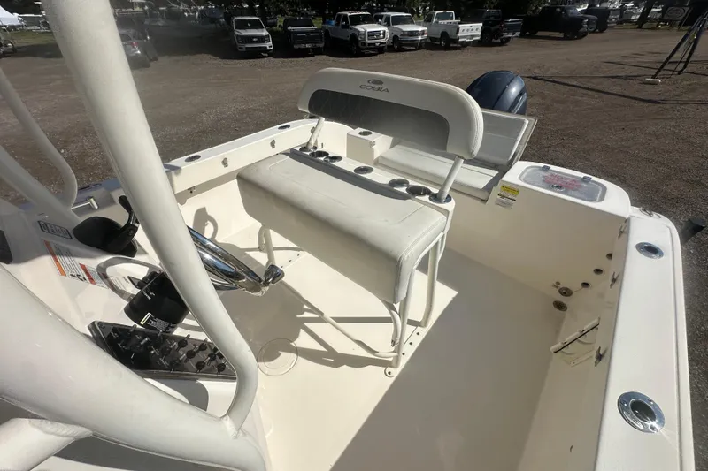 Slide: The Image of 2023 Cobia 220 Center Console boat interior with steering wheel and seating. - 25