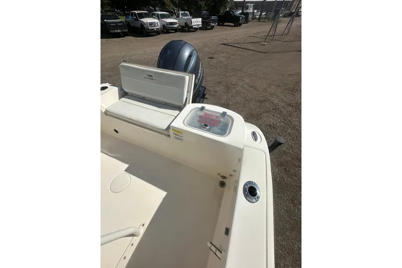 Slide: The Image of 2023 Cobia 220 Center Console boat interior with seating and storage compartments. - 26