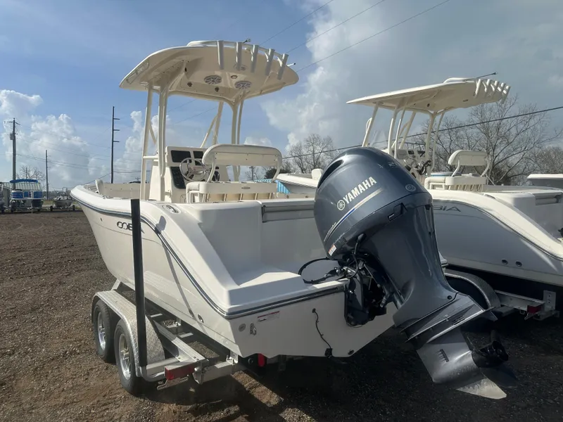 Slide: The Image of 2023 Cobia 220 CC boat with Yamaha engine on trailer, parked outdoors. - 4