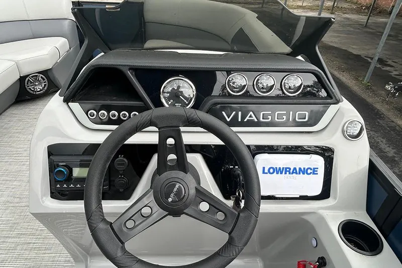 Slide: The Image of 2025 Viaggio Lago V-R boat dashboard with steering wheel and control panel. - 12