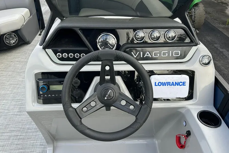 Slide: The Image of Viaggio Lago V-R 2025 boat dashboard with steering wheel and control panel. - 34