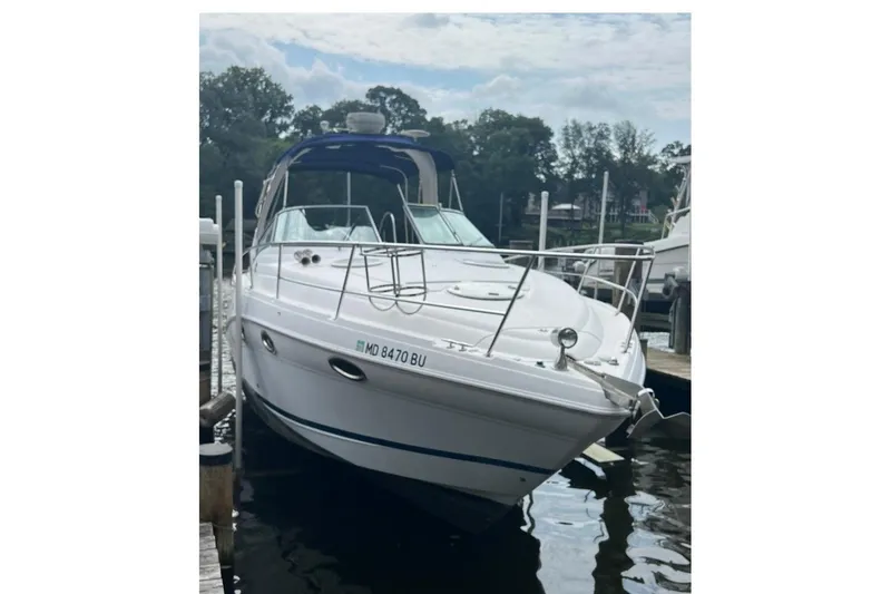 Slide: The Image of 2006 Four Winns 318 Vista boat docked on a calm waterway. - 2