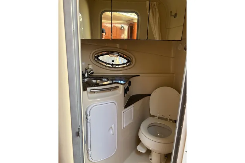 Slide: The Image of 2006 Four Winns 318 Vista boat bathroom with sink, toilet, and mirror. - 6