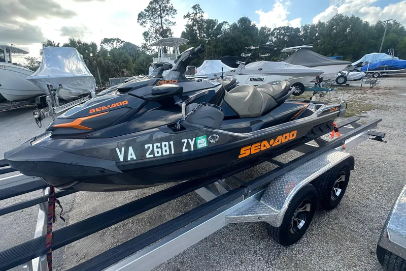 Slide: The Image of 2021 Sea-Doo GTX 300 jet ski on trailer, parked outdoors. - 6