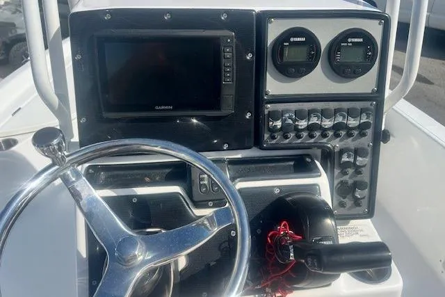 Slide: The Image of 2019 Blue Wave 2200 PureBay boat dashboard with steering wheel and control panel. - 11