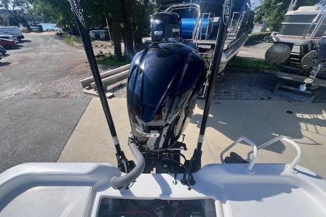 Slide: The Image of 2019 Blue Wave 2200 PureBay boat with powerful outboard motor, docked outdoors. - 6