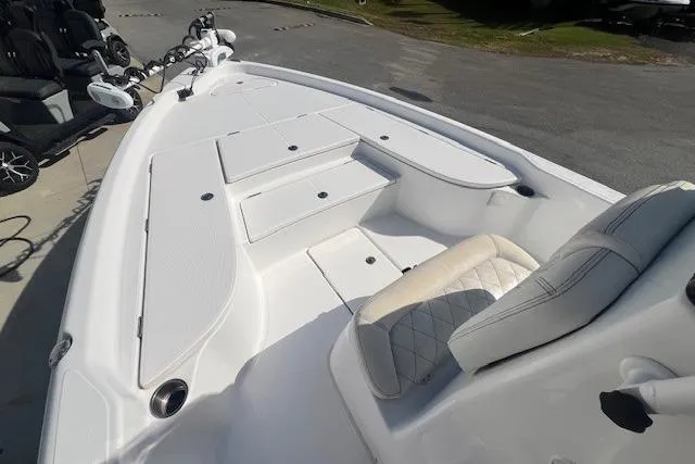 Slide: The Image of 2019 Blue Wave 2200 PureBay boat interior with white seating and storage compartments. - 7