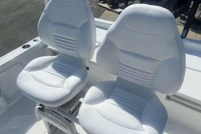 Slide: The Image of Two white cushioned seats on a 2019 Blue Wave 2200 PureBay boat. - 9