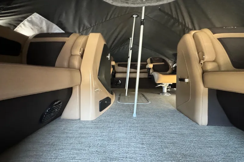 Slide: The Image of Interior of 2023 Barletta Cabrio 22UC pontoon boat with tan seating and carpeted floor. - 11